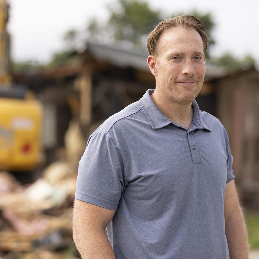  Cy Willson stands near a school site